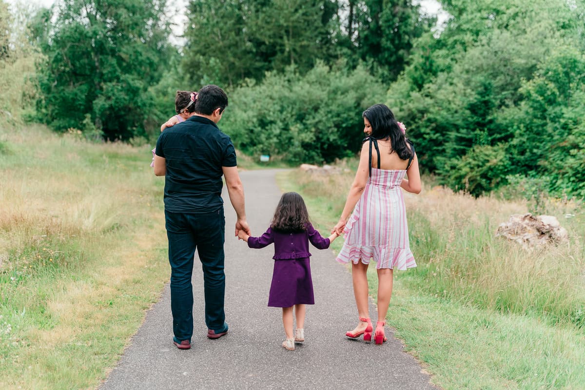 Ritika walking with her family on a quiet path